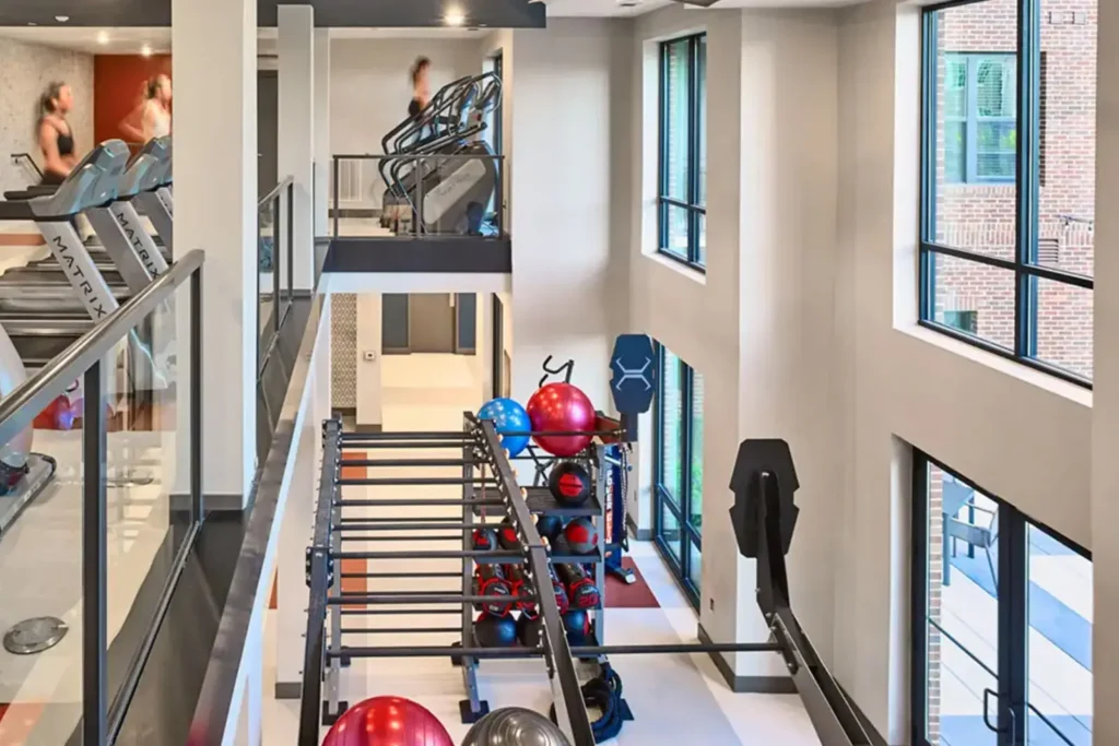Modern fitness center with cardio machines and training equipment at 320 West Mag, student apartments near Auburn University.