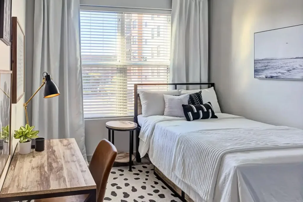 Bright student apartment bedroom with workspace at 320 West Mag in Auburn, AL.